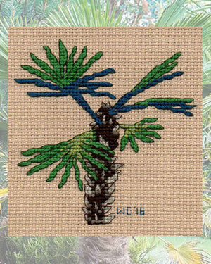 Tropical Chusan Palm Tree Cross Stitch Pattern features the beautiful green and blue palm leaves and brown trunk which is part of the Tropical Palms Cross Stitch Pattern Download PDF for sale at Raspberry Lane Crafts.  Designed by Wendy Christine American artist and designer at www.raspberrylanecrafts.com
