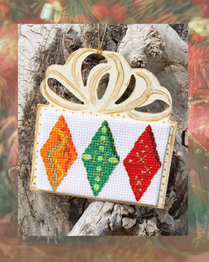 Three Orange Green and Red diamonds with gold highlights cross stitch pattern on present shaped wooden ornament with gold paint details adorn this pattern part of the Gothic Ornaments Cross-Stitch Pattern of three patterns included by Wendy Christine American artist and designer at Raspberry Lane Crafts for sale buy purchase original patterns not available anywhere else.  Digital PDF Download
