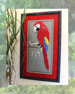 Framed picture with red matting and brown frame of scarlet macaw cross stitch completed project.  Red Scarlet Macaw on Clay Cliffs cross stitch pattern PDF digital download for sale buy purchase at Raspberry Lane Crafts www.raspberrylanecrafts.com by Wendy Christine.  Thanks for your purchase!