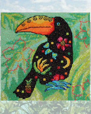 Fruity Toucan Cross Stitch Pattern completed design features an large-billed black toucan with pink flowers, green leaves, yellow bananas and pineapple decorated body with colorful spots on a leafy green background.  Buy purchase for sale PDF Pattern available at Raspberry Lane Crafts.