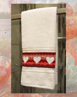 Heart Waves towel cross stitch pattern download PDF features wavy background of red pink and burgundy with three heart shapes in white.  Heart Waves is one of three designs in the Valentine Towels cross stitch pattern for sale at Raspberry Lane Crafts designed by Wendy Christine American designer