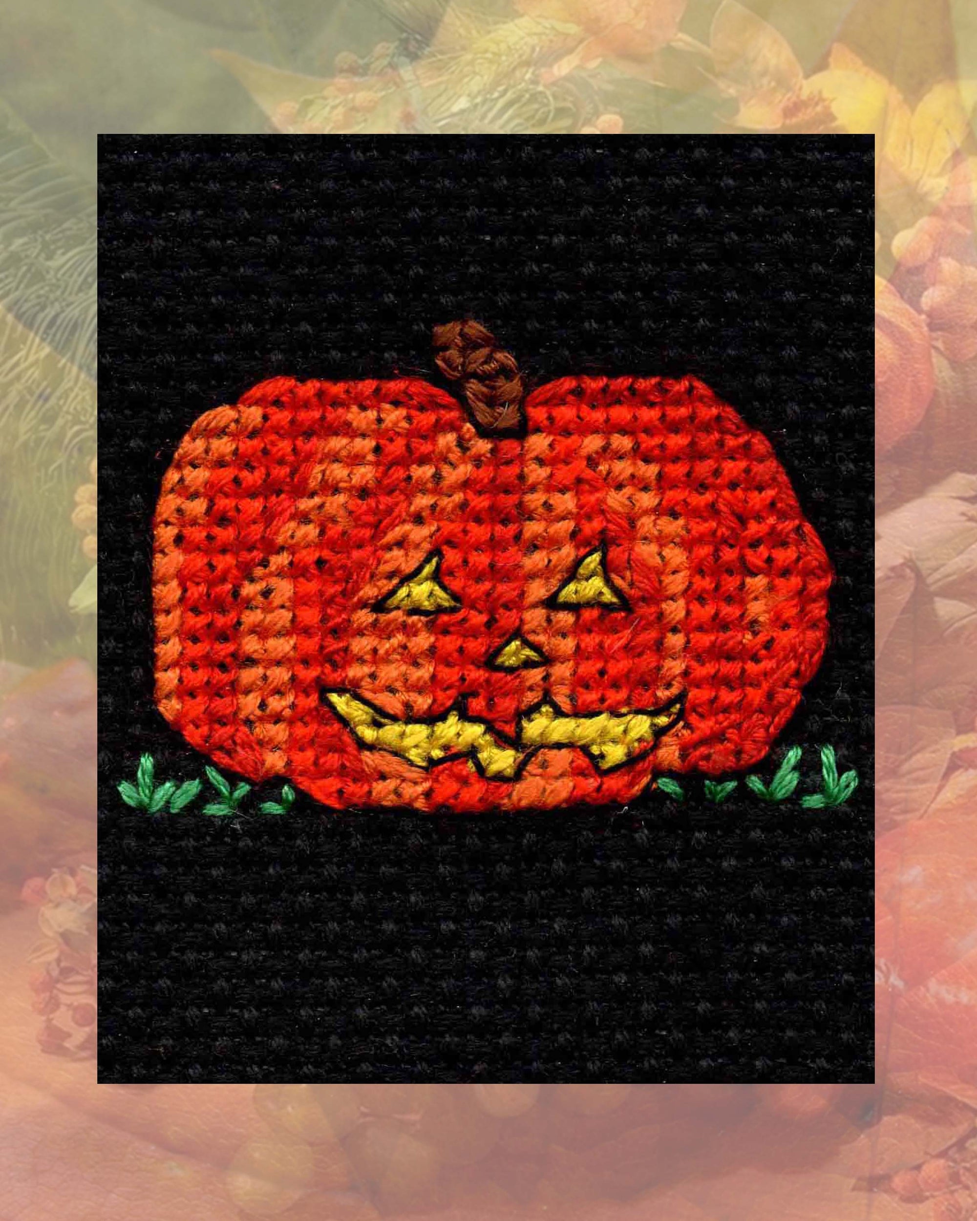 Halloween Jack-o-Lantern orange pumpkin with yellow eyes nose and mouth in green grass cross stitch pattern is one of four 4 cross-stitch patterns in the Halloween Night Collection available for purchase at www.raspberrylanecrafts.com designed by Wendy Christine American artist and designer.  Available internationally as a PDF digital file download emailed to your email anywhere in the world.  Original designs only found here.  Thank you for your purchase and support of a small woman-owned business.  