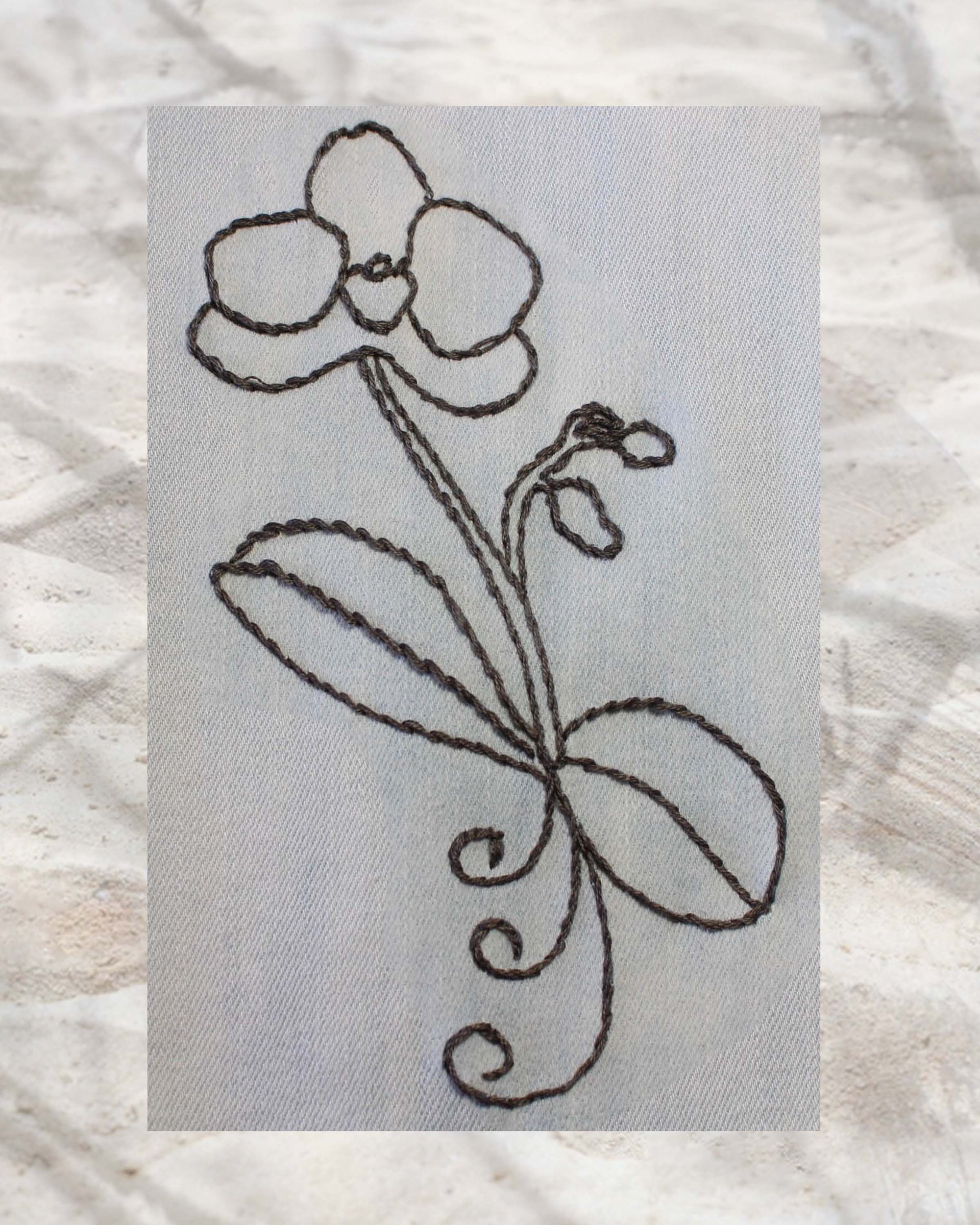 Raspberry Lane Crafts Orchid Majesty Embroidery Pattern PDF Download for sale buy purchase features a round petalled orchid with two buds and round leaves and three curls.  Ideal for embroidering on blue jeans.  Design by Wendy Christine.  One of three designs in the Orchid Fragrance Embroidery Pattern.