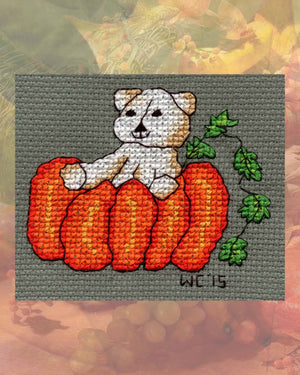 Halloween Cross Stitch Teddy Bear with Giant Orange Pumpkin with green leaves on vine pattern digital PDF download for sale in the four patterns included Four Scary Bears by American artist Wendy Christine at Raspberry Lane Crafts