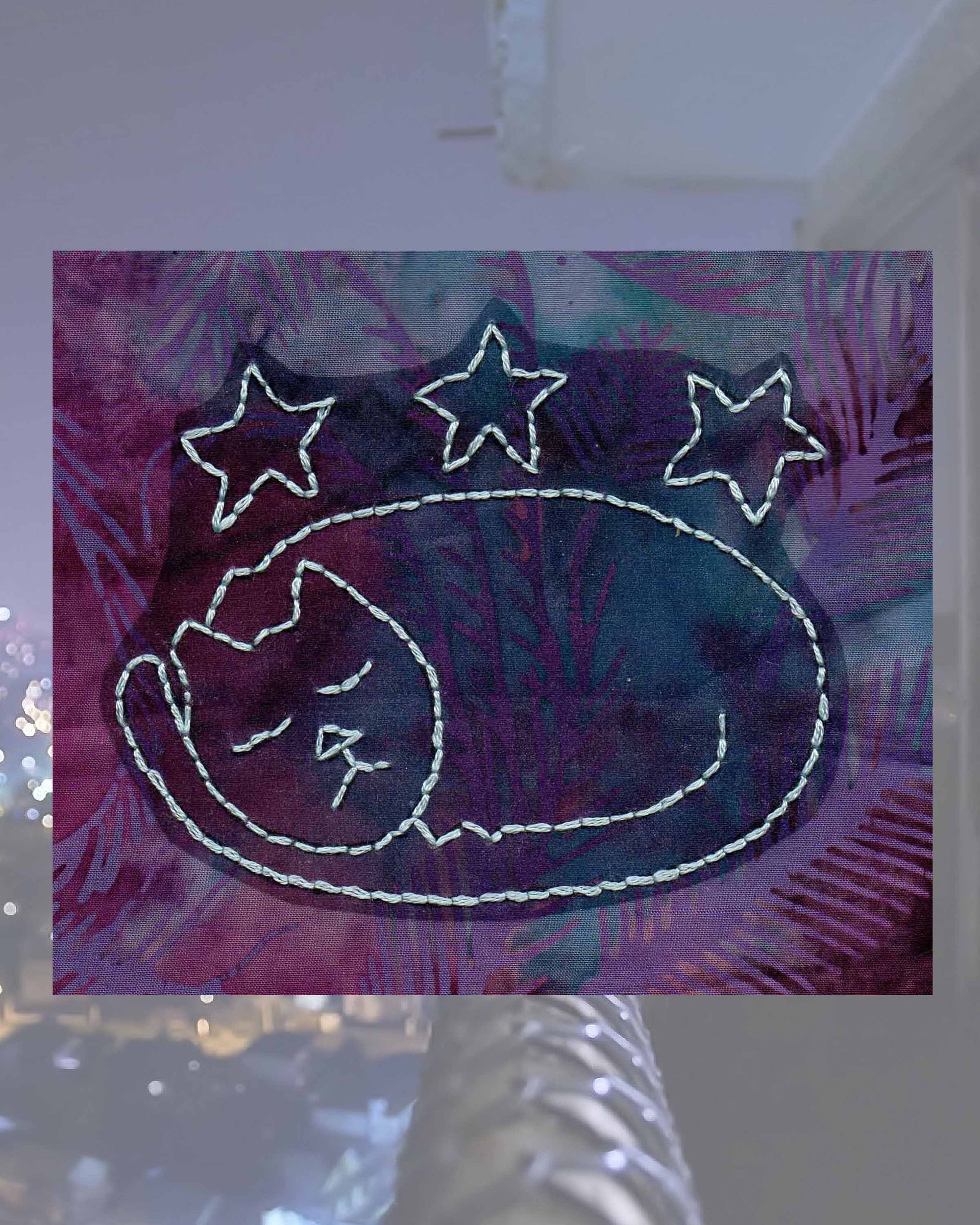 Raspberry Lane Crafts Starry Cat Embroidery Pattern PDF Download for sale buy purchase features a sleeping cat with tail curled around its body with three stars above it.  Design by Wendy Christine.  One of three cat designs in the Kitty Bazaar Embroidery Pattern.