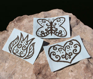 Lace in Blue Cross Stitch Pattern download features outlines with swirls and dots of a heart shape tulip with leaves and butterfly.  Try stitching on different colors AIDA cloth or perforated paper.  Simple elegant design for home decorating from Raspberry Lane Crafts.  Designed by American artist Wendy Christine