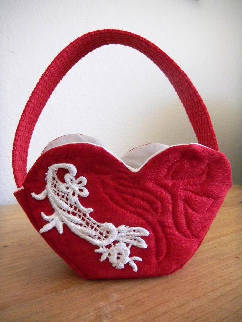 Heart Basket Pattern PDF Download pictured is a small red quilted heart shape basket with lace decoration model.  Pattern for sale at www.raspberrylanecrafts.com