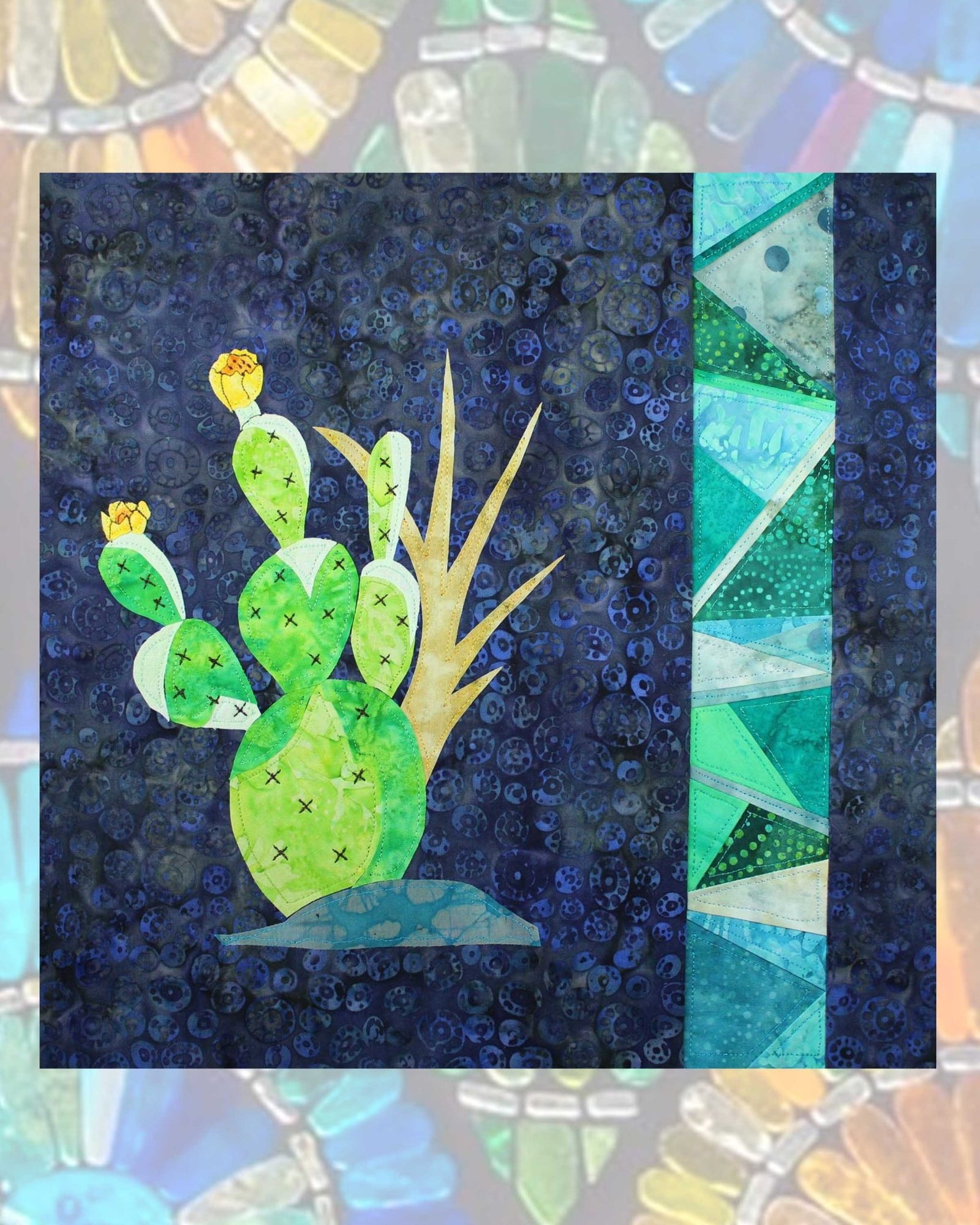 Prickly Pear with Stained Glass Quilt Pattern Download features a prickly pear with yellow flower buds a spiky weed stalk on a mound of dirt with a strip of paper pieced aqua fabriks that look like stained glass strip.  One of four quilt patterns in the Stained Glass Cactus quilt pattern PDF download for sale buy purchase at Raspberry Lane Crafts www.raspberrylanecrafts.com
